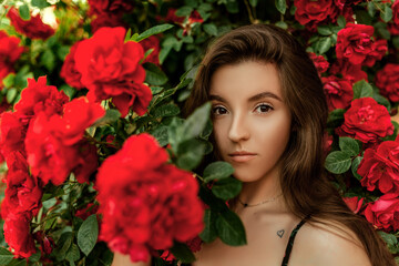 Naklejka premium Portrait of a beautiful Girl in red roses.