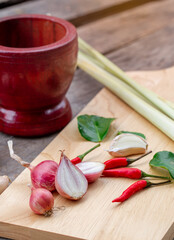 Fresh herbs and spices with wooden mortar on wooden background, (concept thai food)