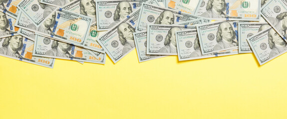 One hundred dollar banknotes on colored background top view, with empty place for your text business money concept. One hundred dollar background.