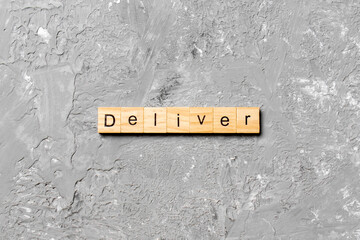 deliver word written on wood block. deliver text on table, concept