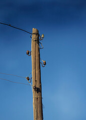 Electric wires against the blue sky