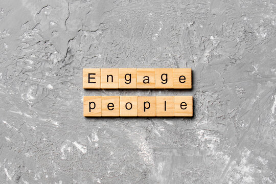 ENGAGE PEOPLE Word Written On Wood Block. ENGAGE PEOPLE Text On Cement Table For Your Desing, Concept