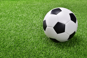 Fototapeta na wymiar Soccer ball on green grass.