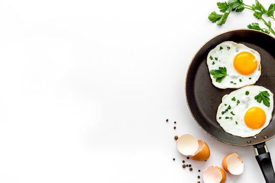 Fried Eggs On Frying Pan - Breakfast - On White Table From Above Space For Text