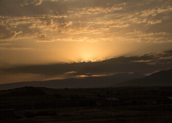 
Sunset in the village over meadows and mountains