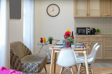 Modern interior of kitchen in spacious studio apartment. Private house. Set table. Stylish kitchen set. Cozy sofa.