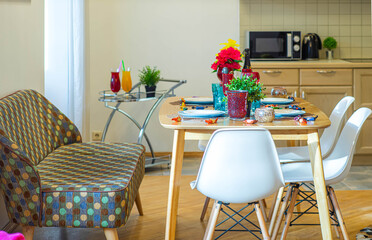 Modern interior of kitchen in spacious studio apartment. Private house. Set table. Stylish kitchen set. Cozy sofa.