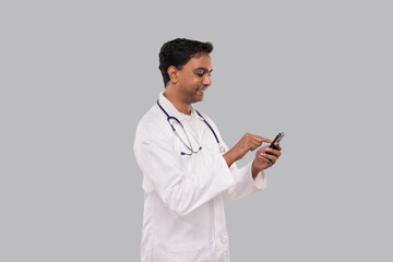 Doctor Chatting on the Phone Isolated. Indian Man Doctor With Phone. Online Medicine Tap