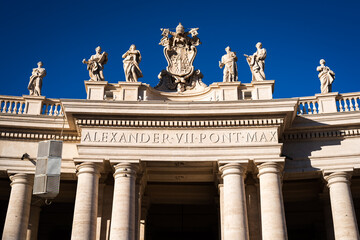 Fototapeta na wymiar Statues above the columns of the arches around St. Peter's Square at the entrance to the Vatican in Rome