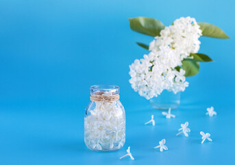 A bottle of fragrant oil made from white lilac flowers. Aromatherapy. Cosmetics. copyspase