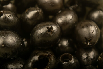 Black olives without seeds. Close up. Surface texture.