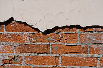 Cracked white grunge brick wall textured background stained old