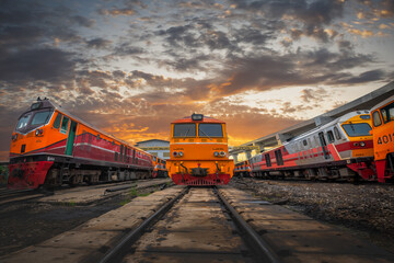 Thai trains on railways during sunset with beautiful sky and clouds.