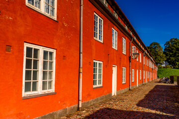 Fototapeta na wymiar Red building in Kastellet, Copenhagen, Denmark, is one of the star fortresses in Northern Europe