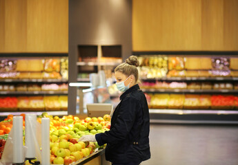 Supermarket shopping, face mask and gloves,Woman buying fruits at the market.