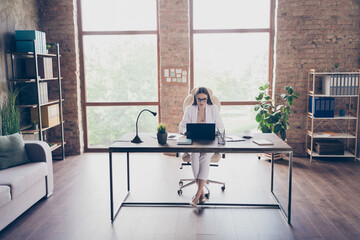 Full length photo of pretty attractive business lady browsing notebook table concentrated work website freelancer remote work home office quarantine formal wear suit stilettos indoors