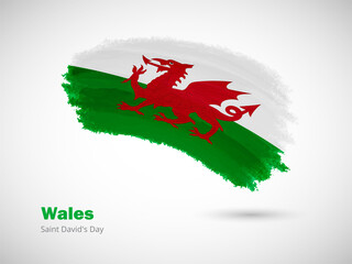 Happy saint davids day of Wales with artistic watercolor country flag background. Grunge brush flag illustration