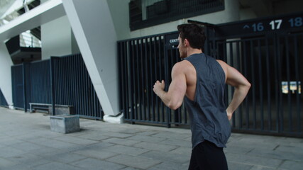Fototapeta na wymiar Athlete man training obstacles run on city street. Fitness guy jogging outdoor.