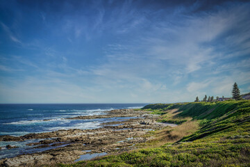 Fototapeta na wymiar A wide angle landscape photo of a rocky coast during low tide.