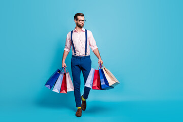 Full body photo of handsome business man worker carry many bags buy clothes vacation shopping...