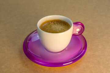 Black cup coffee on beige background. Roasted coffee background, top view. 