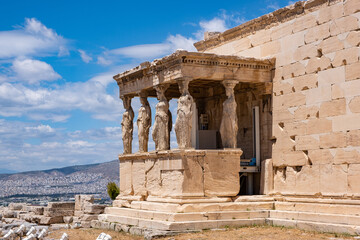 Obraz premium Athens, Greece. Erechtheion with Cariatides Porch on Acropolis hill, blue sky background