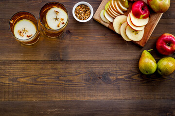 Fruit drinks with apple and pear on wooden table top-down copy space