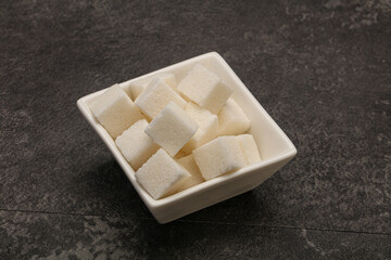 Refined white sugar cubs in the bowl