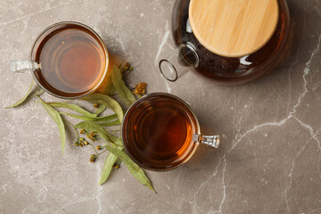 Fototapeta na wymiar Composition with linden tea on gray background, top view. Natural tea