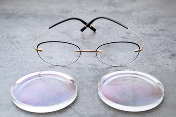 Closeup of fashion trendy eyeglasses lying on table in optical store with new lenses. Professional...