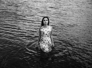 Fototapeta premium Beautiful girl wearing dress near the sea