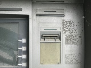 Old, non-working ATM. ATM in the dust. No money.