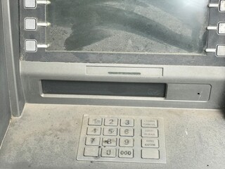 Old, non-working ATM. ATM in the dust. No money.