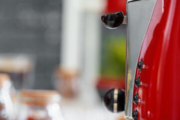 Close up photo of a red toaster on a kitchen table