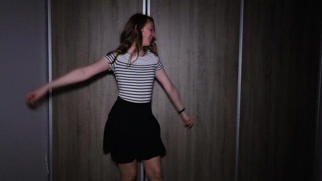 Girl dances in slow motion alone in her room at night