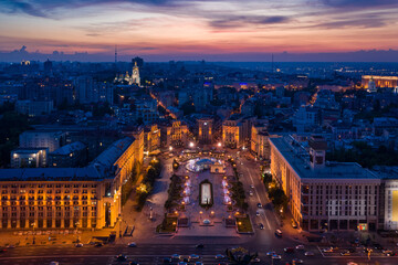 Kyiv (Kiev) Ukraine Maidan Nezalezhnosti (Independence Square) evening illumination fountains and architecture. tourist attraction must visit place of revolution. Aerial drone photo from above - obrazy, fototapety, plakaty