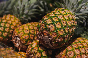 Sweet pineapple at the grocery store. Natural fresh fruit at the market. Closeup view.