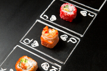 hand drawn Poker cards with Japanese sushi roll pieces on dark chalkboard background. Asian rolls with shrimp, cucumber, salmon and flying fish roe. Jack, Queen and King of Hearts chalk cards
