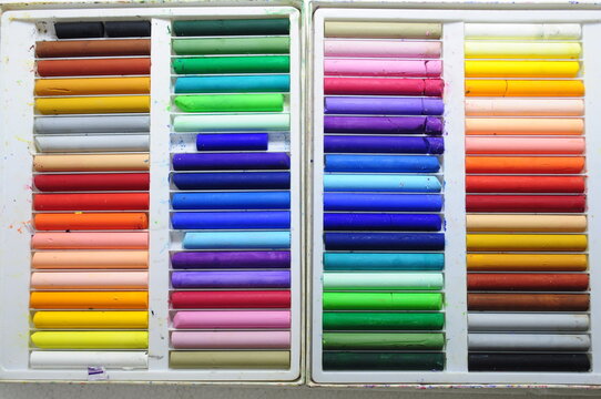 Colored oil pastels arranged in boxes,old colorful crayons, the oil pastel 
