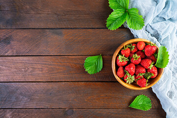 Sweet fresh ripe strawberry isolated on wooden background.