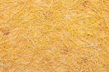 Dry noodles spread over a wood table