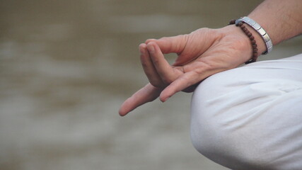 Yoga hand mudra by the ganga