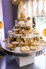 Delicious sweets on candy buffet. Candy bar on wedding ceremony with a lot of different candies.