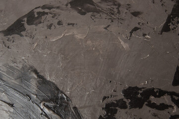 Dark gray concrete or textured putty on the wall, background with copy space.