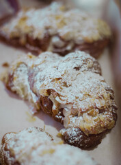 Croissants with almonds, vertical top view.
