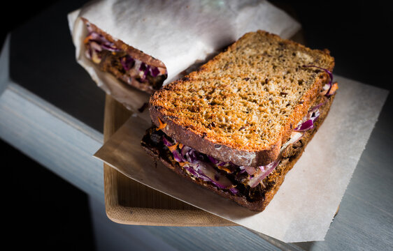 Sandwich From Brown Bread With Pork, On Dark Background In Cafe