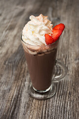a glass of cocoa with cream and strawberries