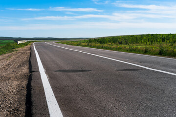 Panoramic photo of an empty highway with rural views, Russian nature