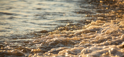 Blurred landscape with waves in sunlight