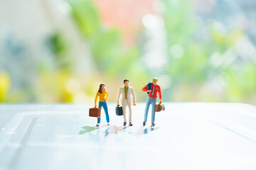 Miniature people, business team standing on sunlight background using as business corporation and business teamwork concept